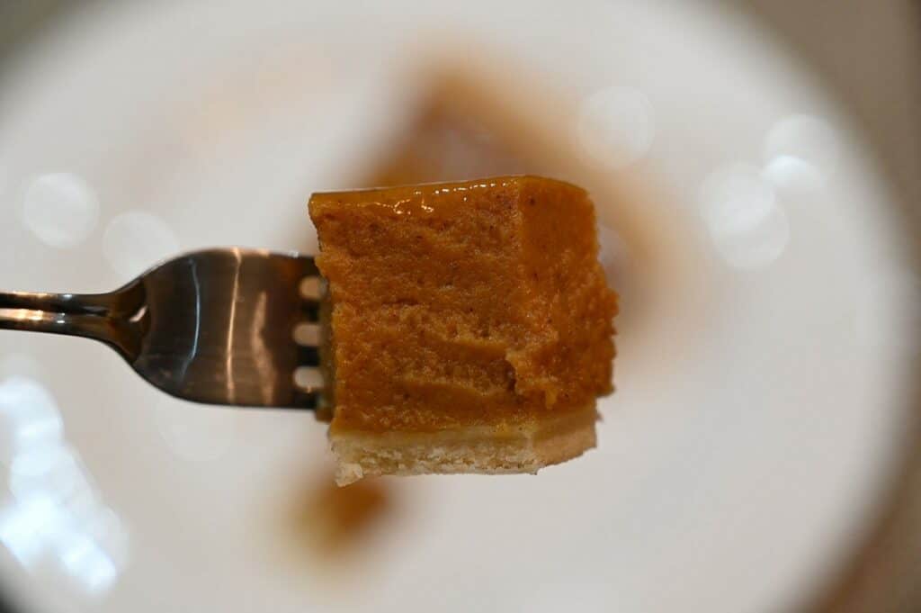 A closeup image of a  forkful of the Pumpkin Pie.