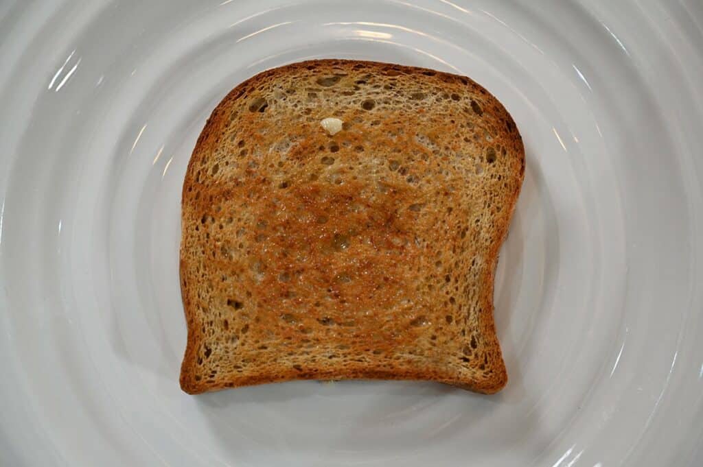 Image of a slice of Costco Carbonaut White Bread toasted with butter and on a plate