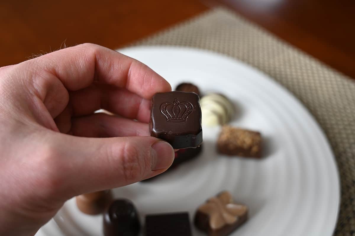 Image of hand holding a Avelie chocolate close to the camera.