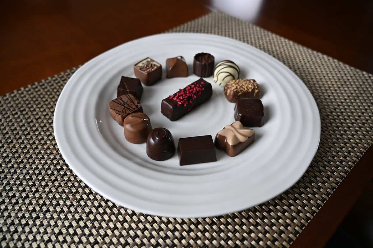 Image of all 13 different kinds of chocolates served on a white plate.