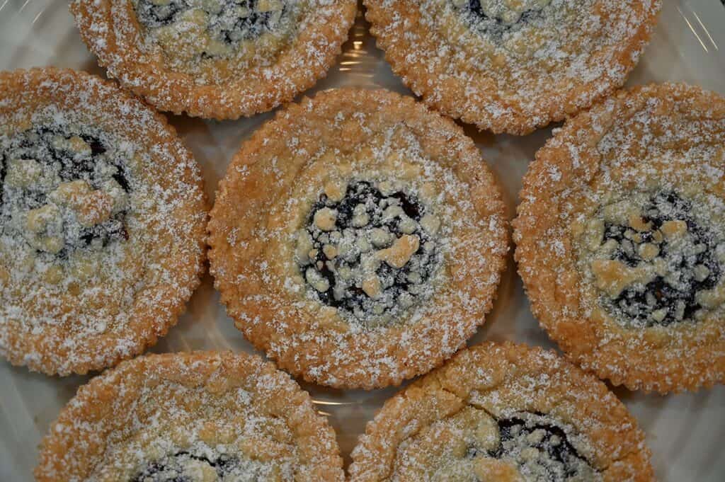 Close up image of a Costco Kirkland Signature Raspberry Crumble Cookies on a plate. Top down image 