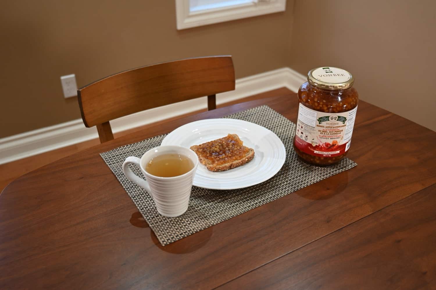 The jar of tea base alongside two of the things you can make with it - toast covered in the tea base and tea made from the tea base.
