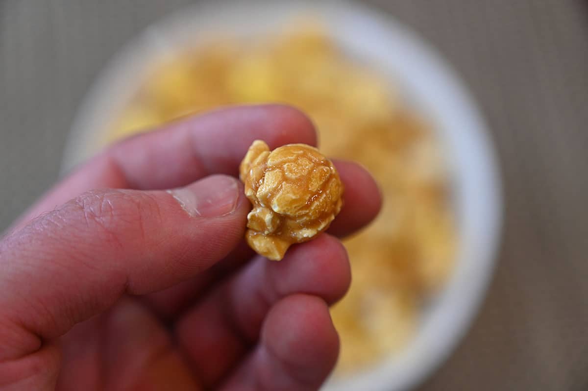 Closeup image of one salted caramel popcorn piece.