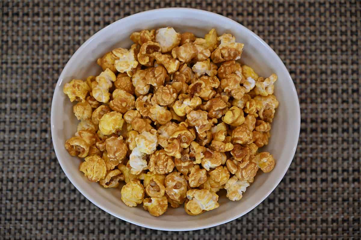 Top down image of a white bowl full of salted caramel popcorn.