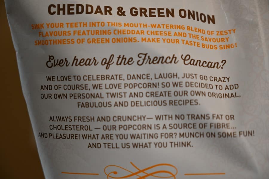 Photo of the bag of French Cancan Cheddar & Green Onion Popcorn talking about the product.