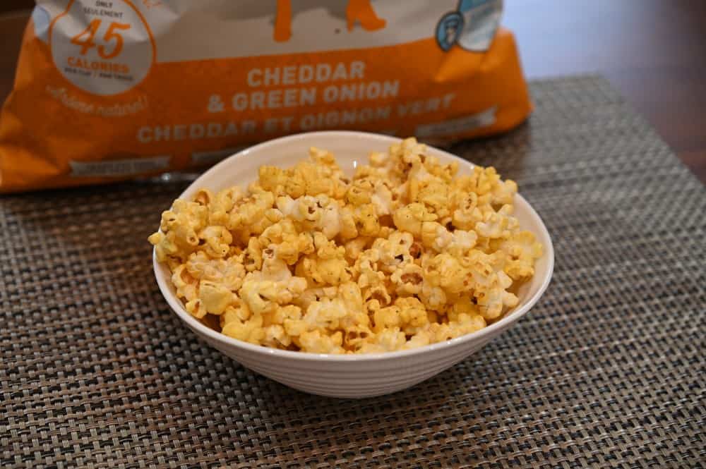 Close-up photo of a bowl of the cheddar & green onion popcorn.