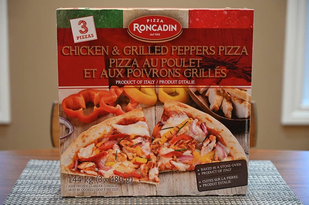 Image of the Costco Pizza Roncadin Chicken & Grilled Peppers Pizza box sitting on a table unopened. 