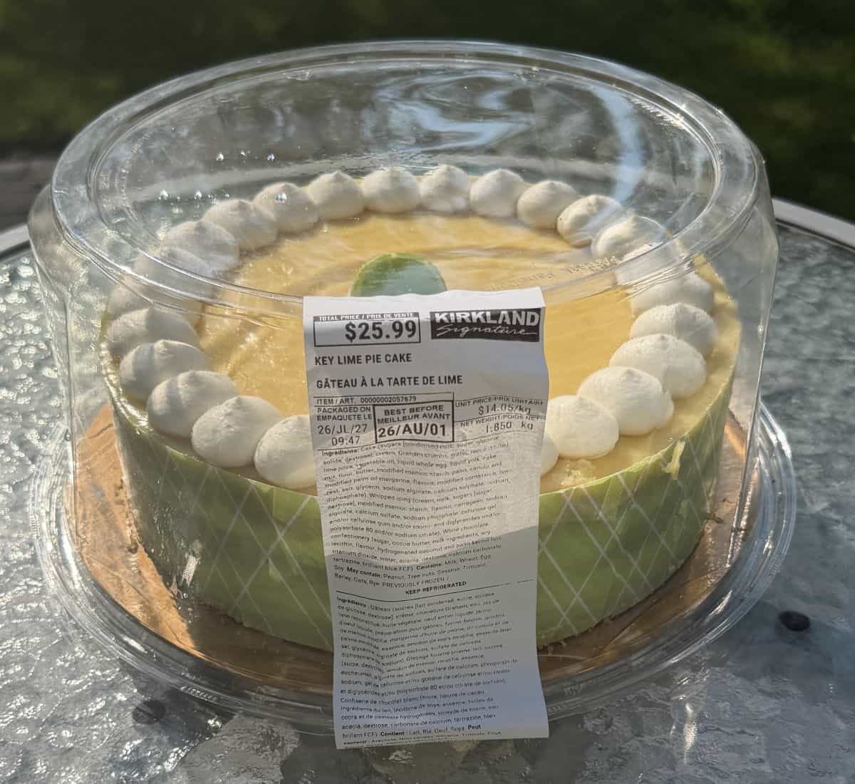 Image of the Costco Kirkland Signature Key Lime Cake sitting outside on a table unopened.