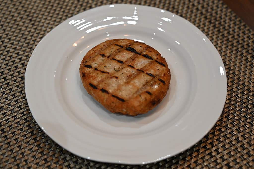 Image of a chicken burger served on a white plate. 