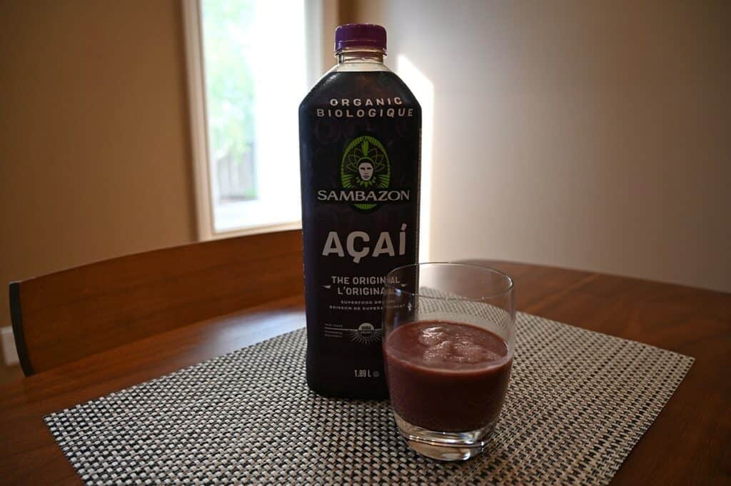 Costco Sambazon Acai Superfood Drink  poured in a glass beside the bottle