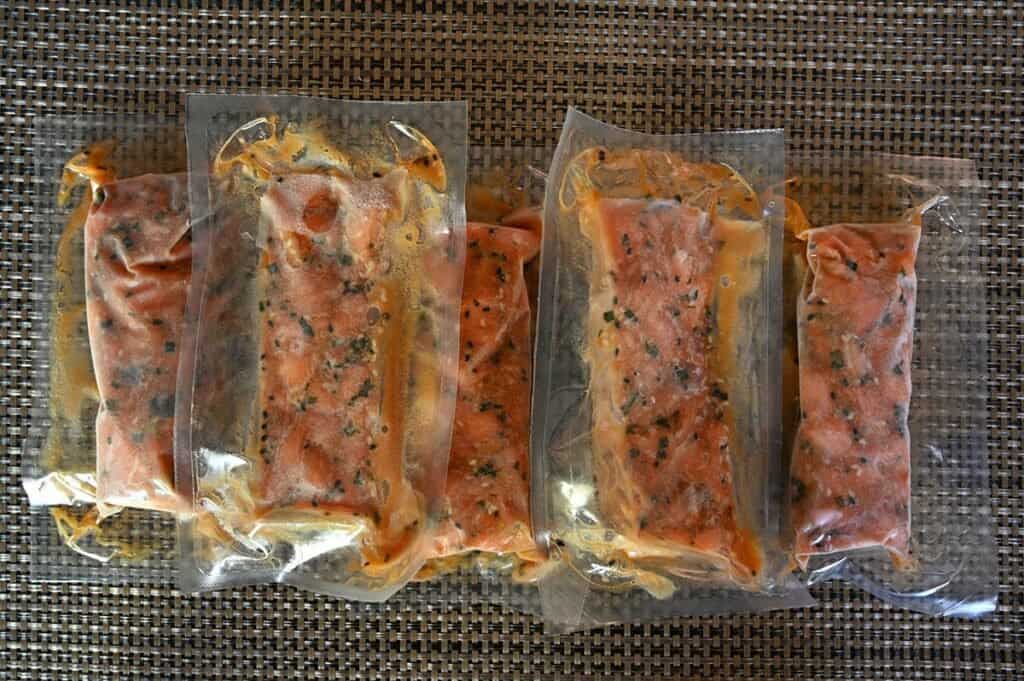 Costco Dom Reserve Singles Steelhead Salmon Poke five single serve packages on table.