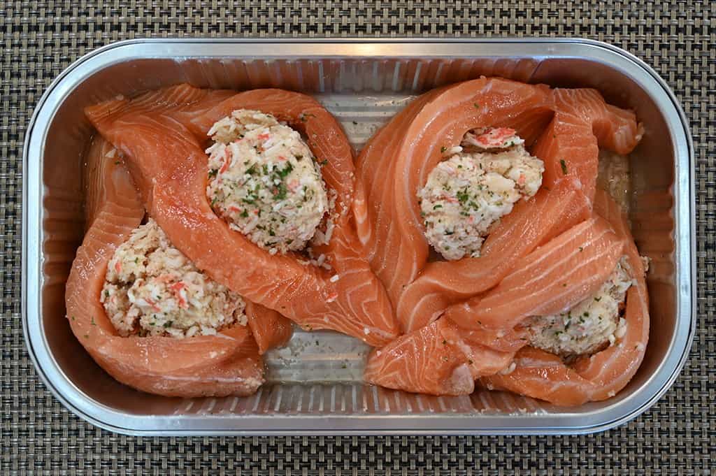 A top-down view of the tray of Kirkland Signature Stuffed Salmon with the lid removed.