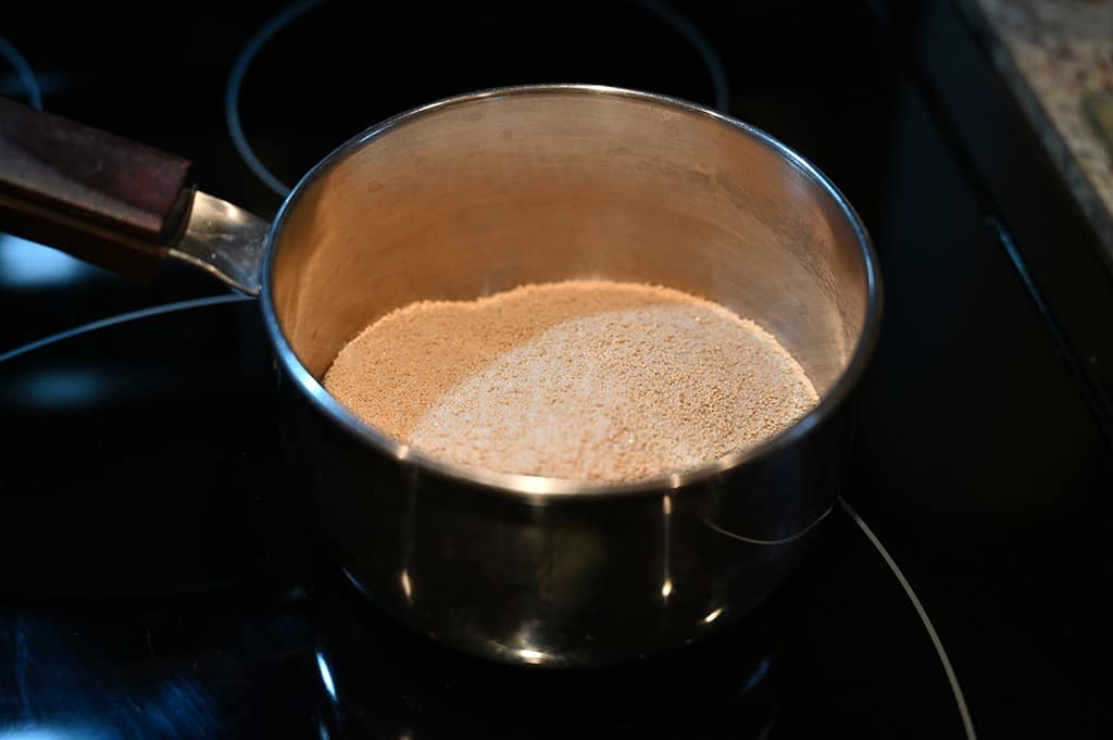 The glaze mix that comes with the Spiral Sliced Ham in a saucepan.