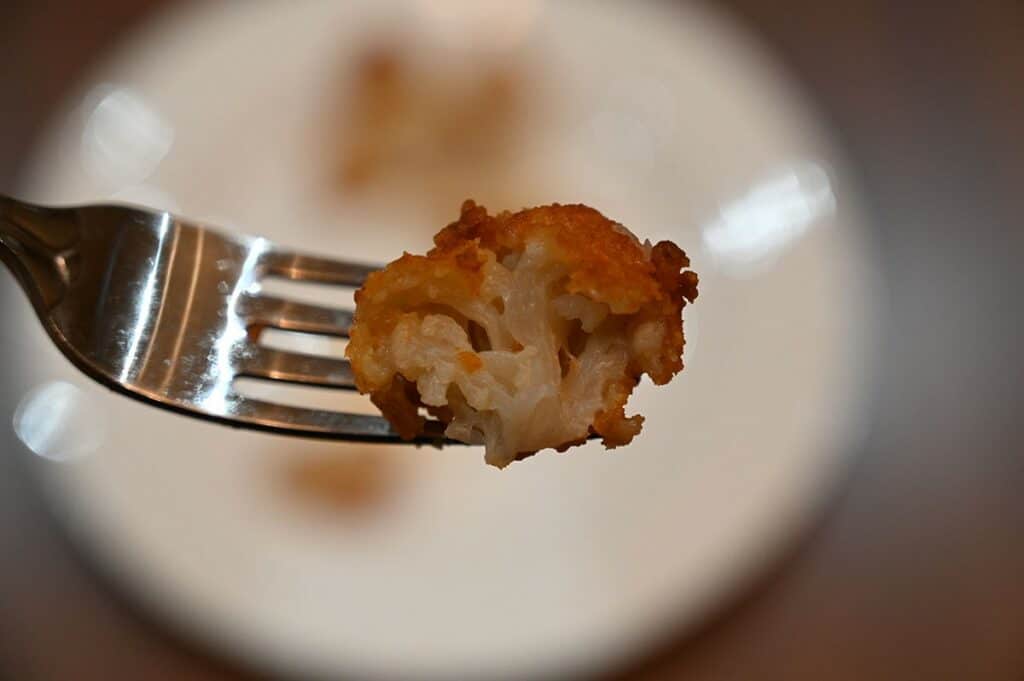 Costco Wholly Veggie Buffalo Cauliflower on a fork with a bite out of it