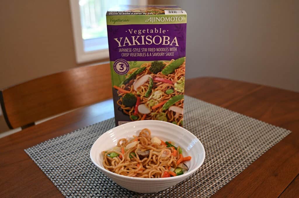 The Vegetable Yakisoba in a bowl in front of the box.