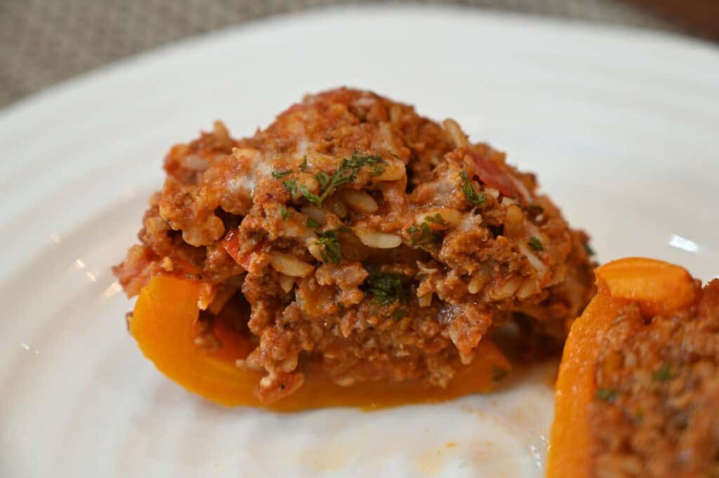 A close-up of a stuffed pepper cut in half to show the filling.