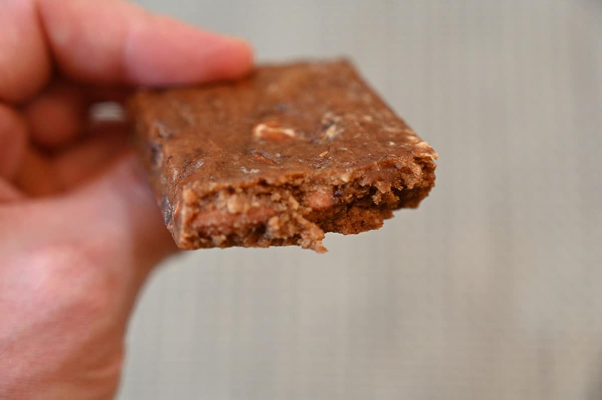 A close-up of the Coconut Chocolate RXBAR with a bite out of it.