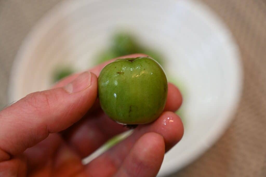 Costco HBF Kiwi Berries whole kiwi berry before biting into it closeup image