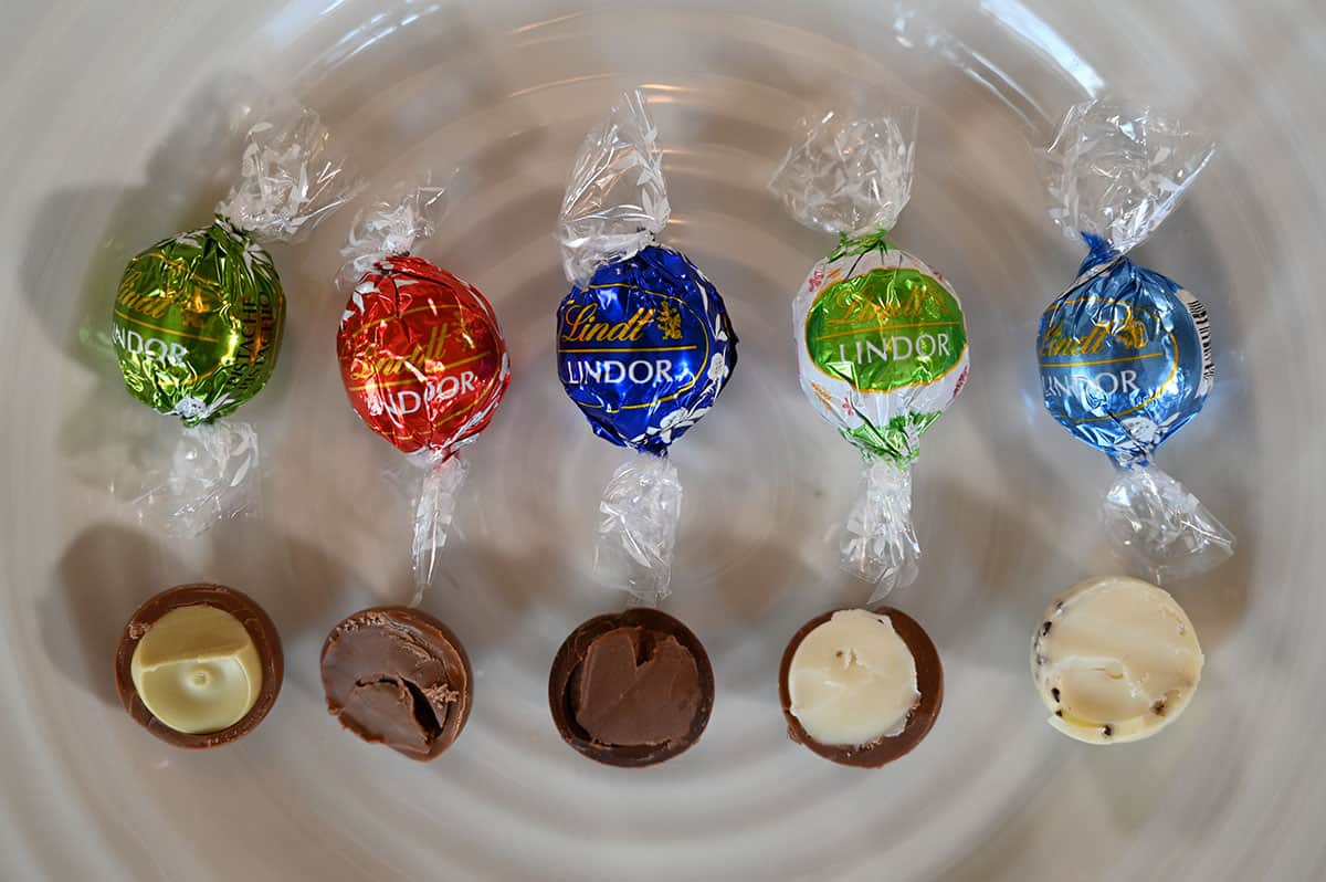 Image of the five different Easter limited edition box lindor chocolates out of the wrapper and cut in half so you can see the inside.