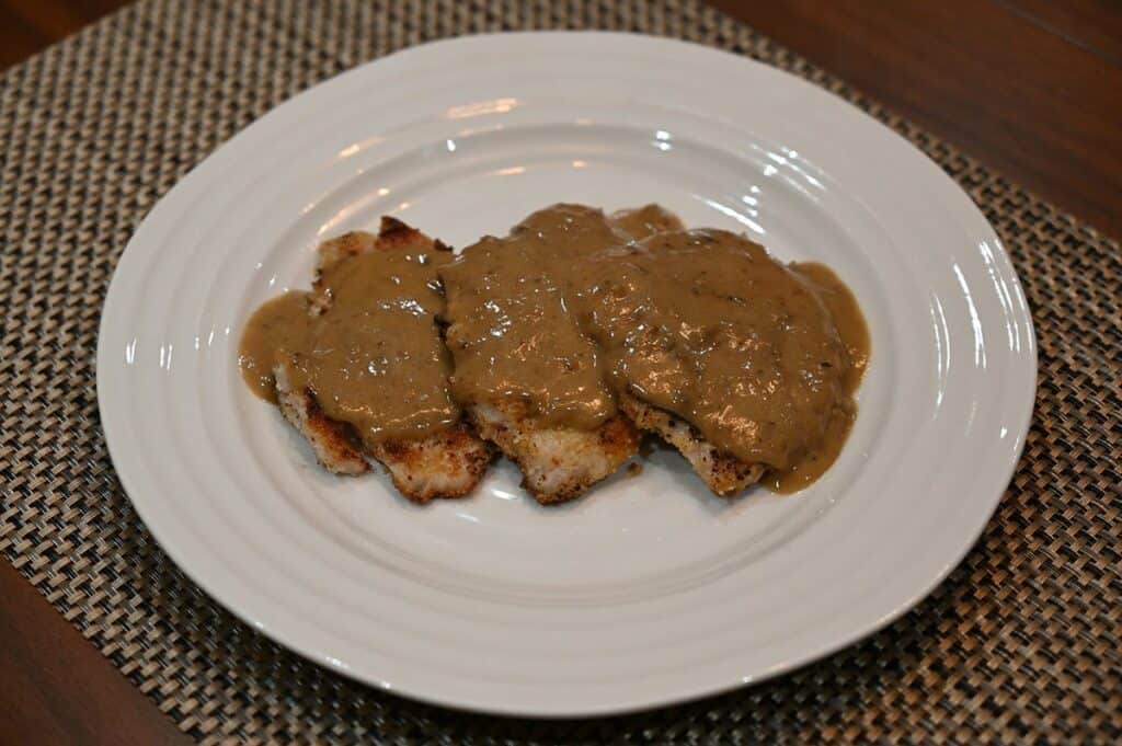 Costco Ventera Pork Schnitzel prepared and on a plate with sauce on top 