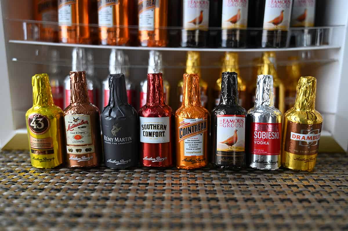 Image of eight wrapped liquor-filled in different flavors standing beside one another in a line.