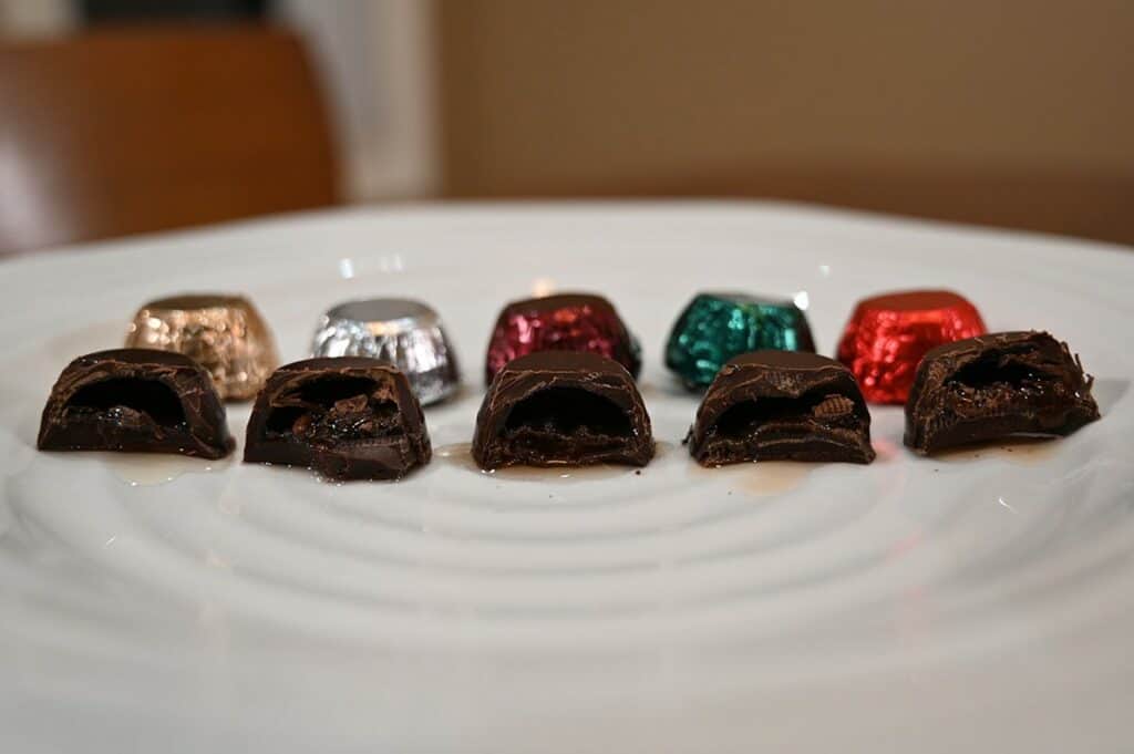 Image of the five different kinds of Costco Kirkland Signature Liquor Collection Belgian Chocolates all unwrapped and with a bite taken out of each one sitting on a plate 