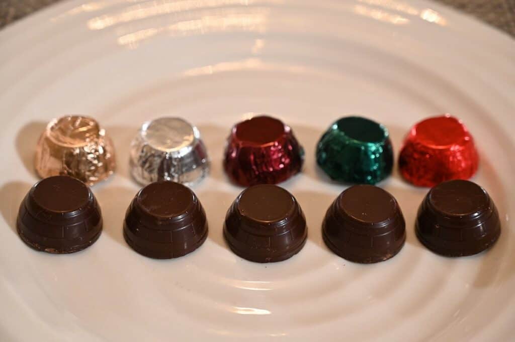 Image of the Costco Kirkland Signature Liquor Collection Belgian Chocolates unwrapped and all on a plate. from left to right XO Coganc, Vodka, Blended Scotch Whisky, Irish Whiskey, Tawny Porto