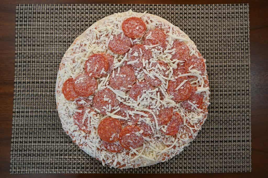 Costco Kirkland Signature Pepperoni Pizza image of pizza still frozen prior to baking 