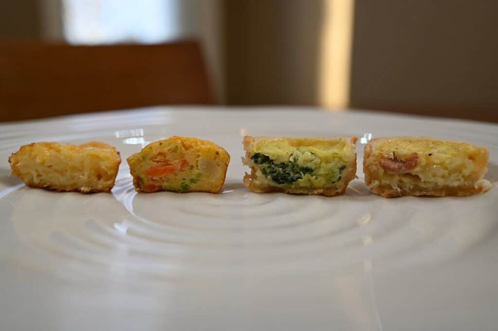 Costco Cuisine Adventures Mini Quiche  image of four quiche on a plate, one of each kind with a bite taken out of each 