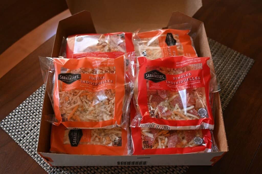 Image of the Costco Sabatasso's Pizza Singles box open showing the individually wrapped pizzas inside 