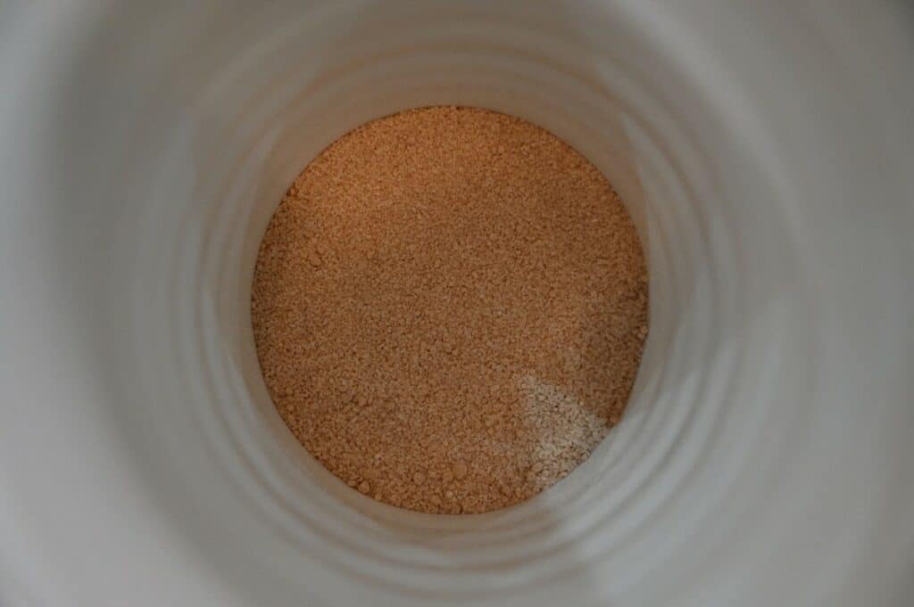 Top down Image of a mug of Costco Alpine Spiced Apple Drink with the powder in the bottom of the mug but no water in it 