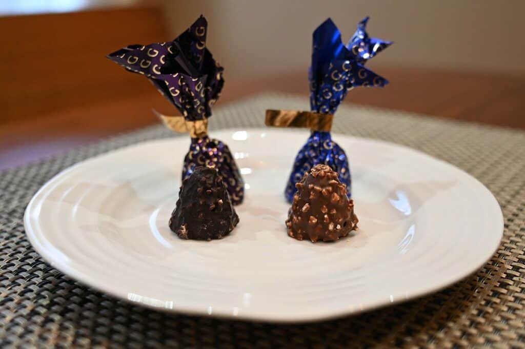 Image of the Costco Godiva Chocolate Domes, both flavors, dark chocolate and milk chocolate unwrapped sitting on a plate, sideview image. 