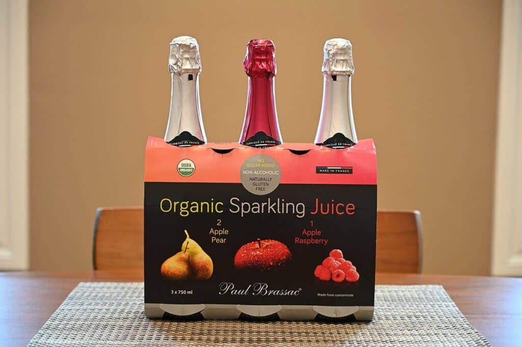 Image of the three pack of Costco Paul Brassac Organic Sparkling Juice sitting on a table with the bottles in the box.