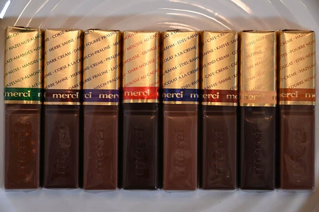 Closeup photo of the eight different Merci European Chocolates on a plate. 