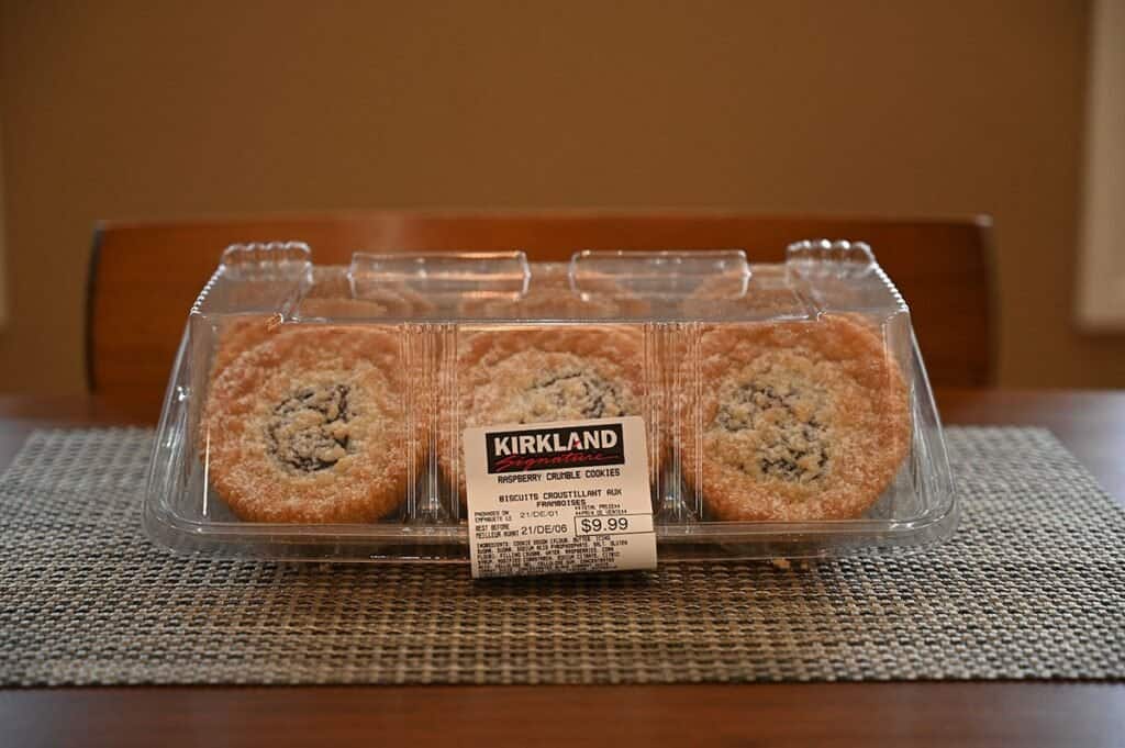 Side image of the Costco Kirkland Signature Raspberry Crumble Cookies in their plastic container sitting on a table 