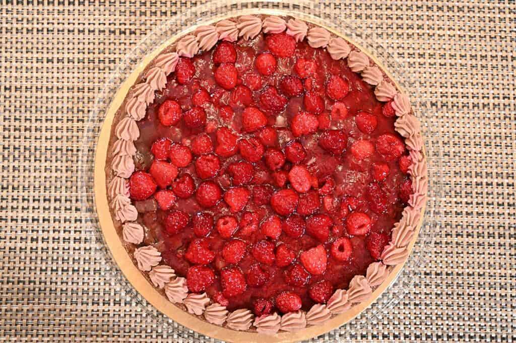 Top down image of the Costco Kirkland Signature Chocolate Raspberry Tart with the container lid off so you can see the tart.
