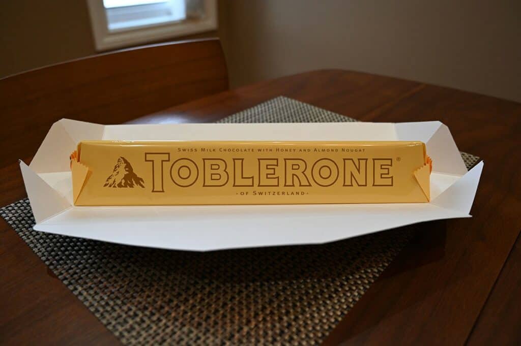 Image of the Costco Toblerone bar out of the box showing the plastic wrapping around the bar inside the box 