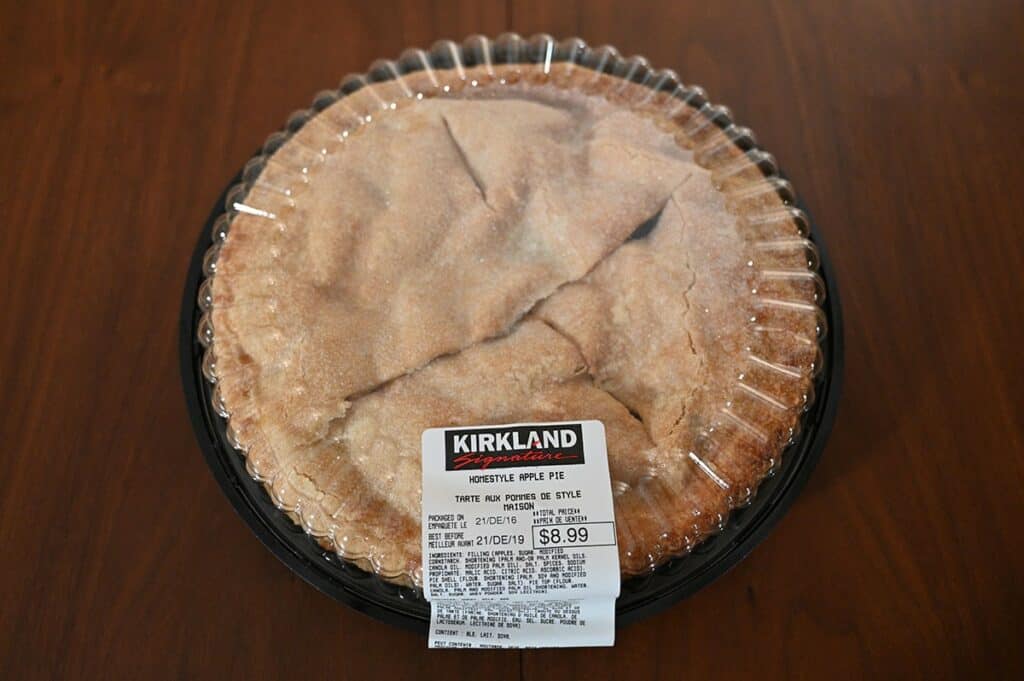 Costco Kirkland Signature Homestyle Apple Pie on a table with the lid on showing the label