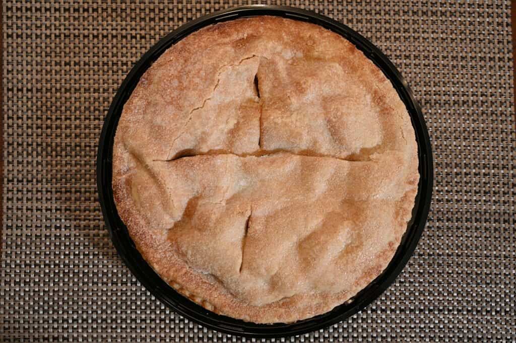 Top down image of the Costco Kirkland Signature Homestyle Apple Pie on a placemet. 