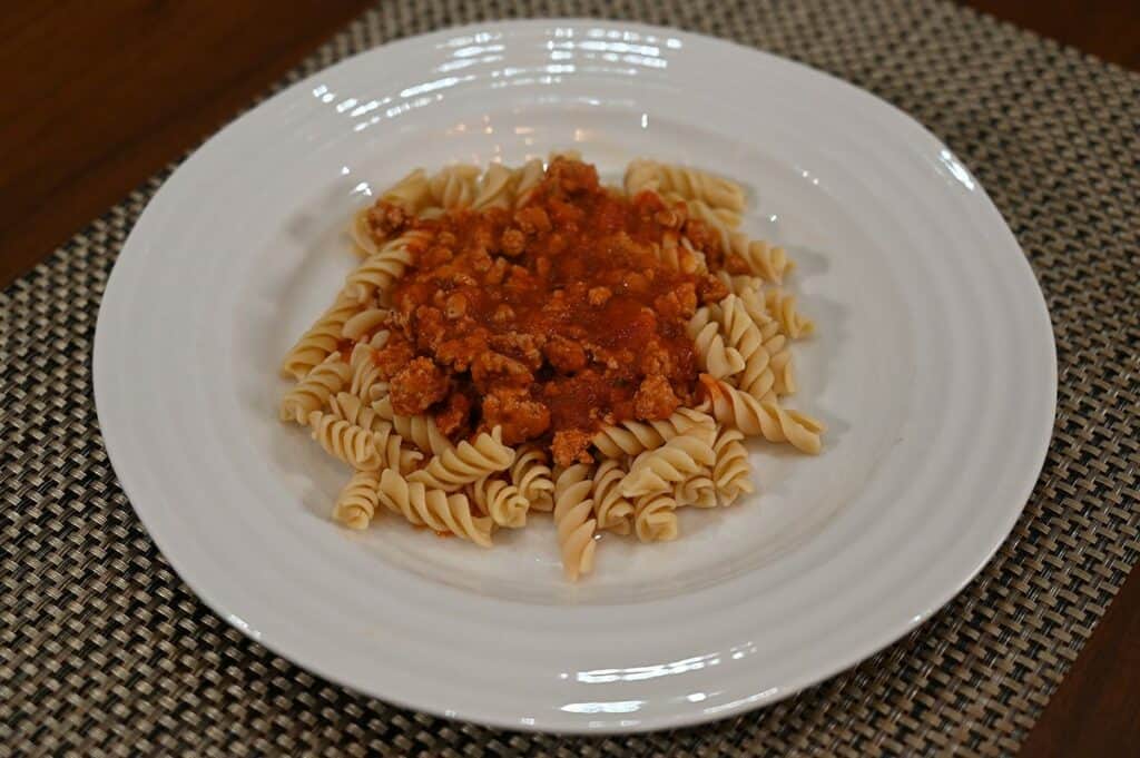 Costco Banza Rotini Chickpea Pasta cooked and served on white plate with tomato sauce. 