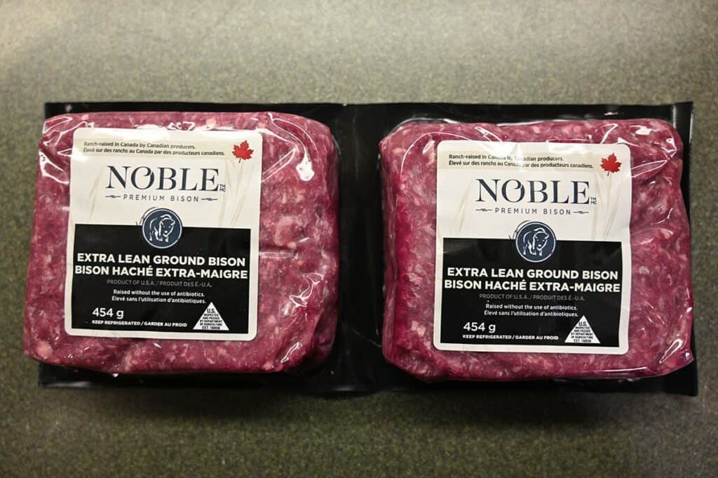 Costco Noble Premium Extra Lean Ground Bison in two-pack sitting on counter 