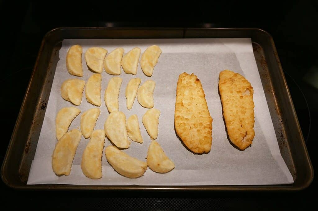 Costco Kirkland Signature Fish & Chips Meal Kit fish and chips on a baking tray to go into the oven