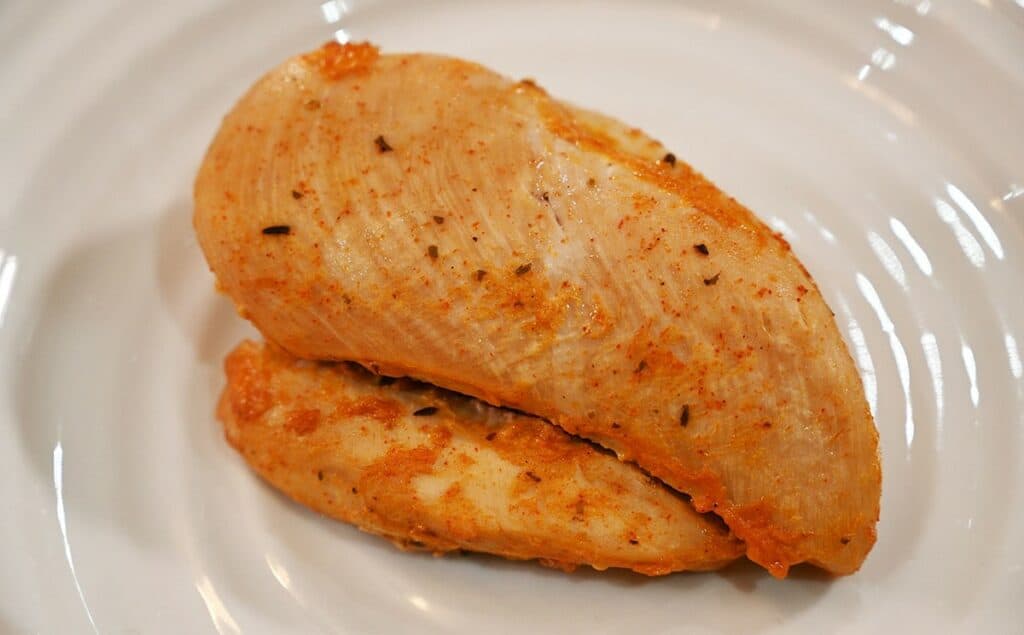 A chicken breast plated on a white plate using the Costco Johnny's Sweet, Hot & Crazy Marinade and Wing Sauce as a marinade. 