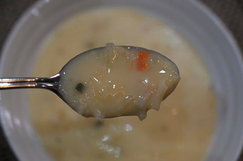 Costco Johnny's Potato Cheddar Soup Mix prepared, close up image of soup on a spoon. 