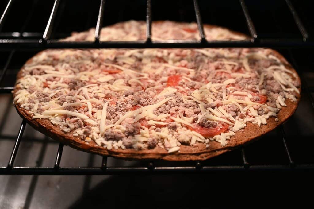Costco Keto Izza Keto Pizza cooking in the oven directly on the rack. 