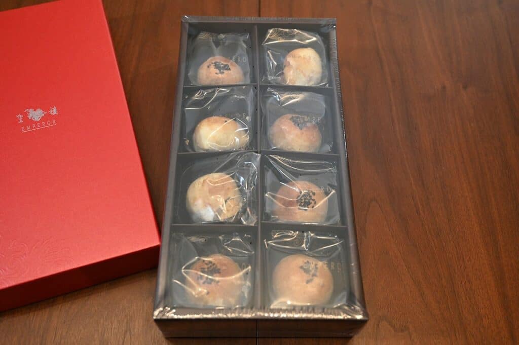 Costco Emperor Lava Pastry with Lotus Seed Paste with the lid off, sitting in the box. Shows eight pastries.