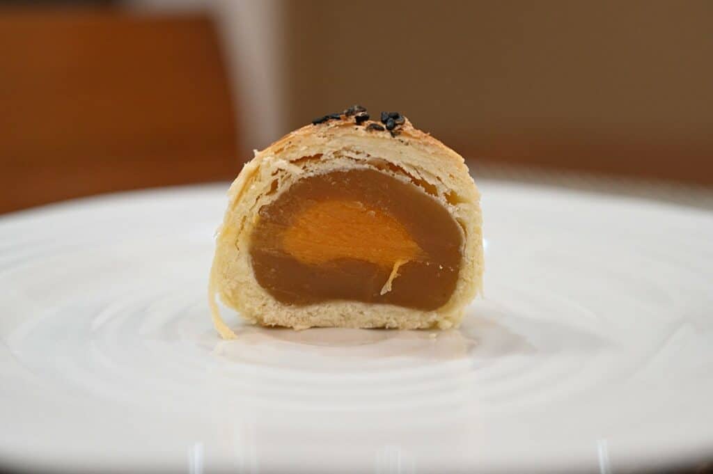 Inside a Costco Emperor Lava Pastry with Lotus Seed Paste on a white paste to show the filling