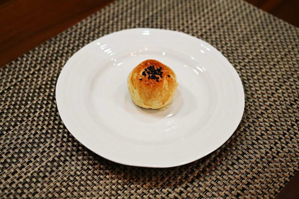 Costco Emperor Lava Pastry with Lotus Seed Paste unwrapped, and on a white plate