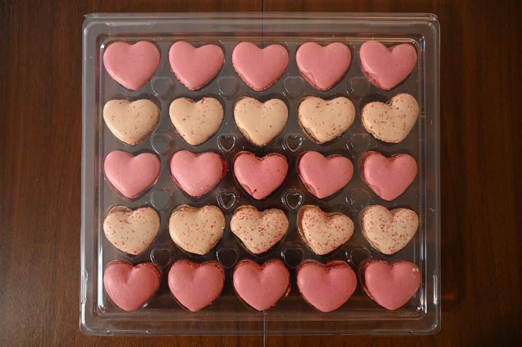 Costco Le Bon Patisserie Heart Shaped Macarons out of the carboard box still in plastic and sitting on a table. 