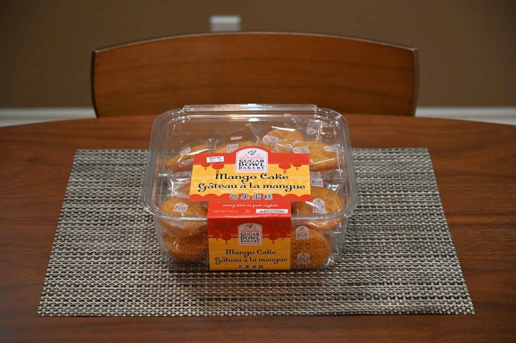 Costco Sugar Bowl Bakery Mango Cake container sitting on a brown table 